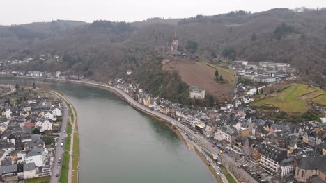 drone flight over the moselle river through cochem in germany with the castle in the background