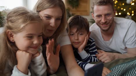 family using smartphone during the christmas