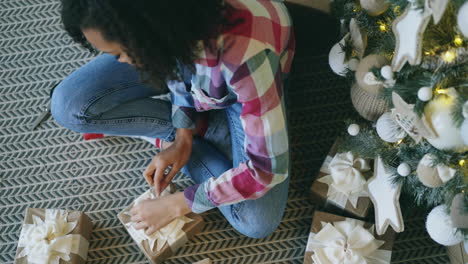 girl wrapping christmas gifts