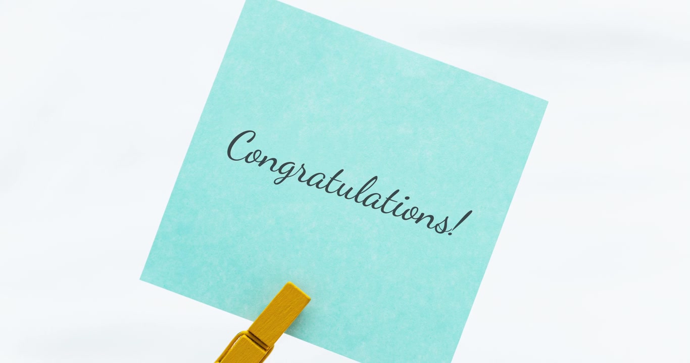 A heartfelt congratulations note captures the essence of achievement in a serene home office setting.