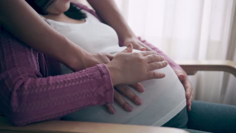 pregnant couple feels love and relax at home.