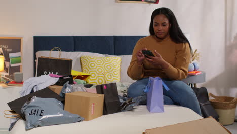 woman shopping online in her bedroom