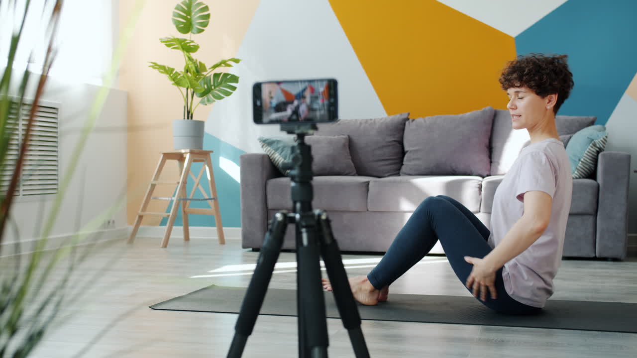 Woman practicing yoga at home, online video session