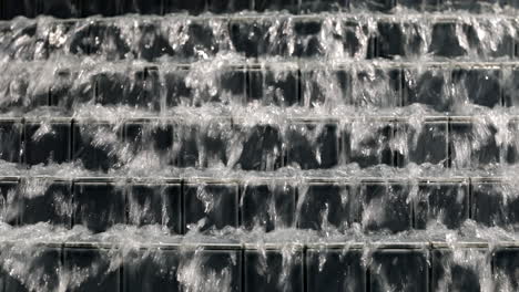 Close-Up-Row-of-Square-Tiles-Lined-up-on-Stairs-With-water-Sliding