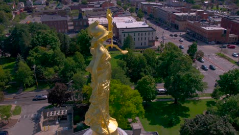 full 360 degree drone shot of the gold justice statue at the top of the beautiful ontario county courthouse in canandaigua, new york near canandaigua lake