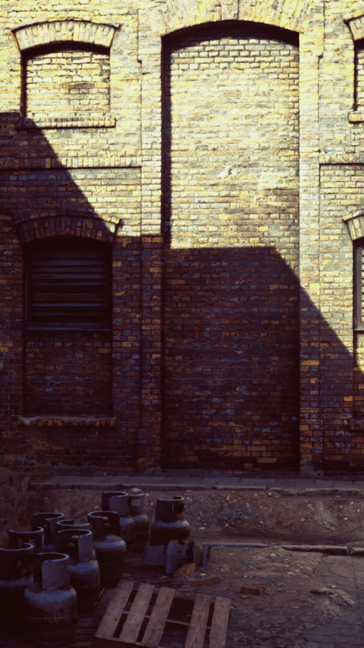 Abandoned warehouse yard bathed in golden afternoon sunlight