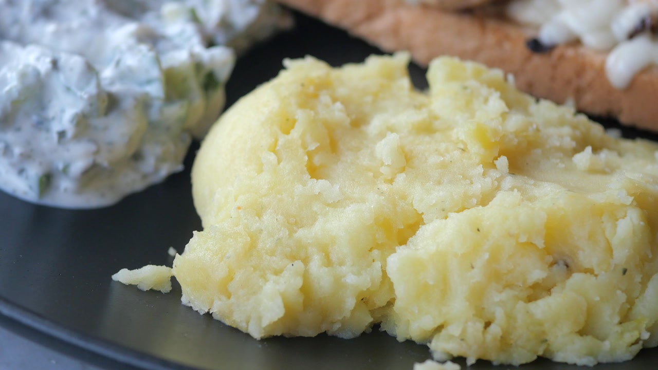Close-up of Creamy Mashed Potatoes on a Black Plate