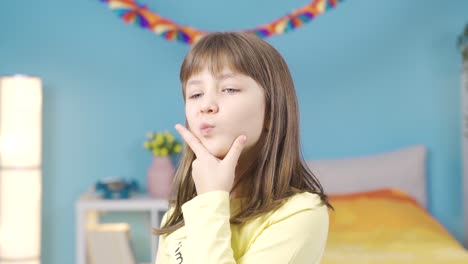 Positive-daydreaming,-thinking-little-girl-with-her-hand-on-her-chin.