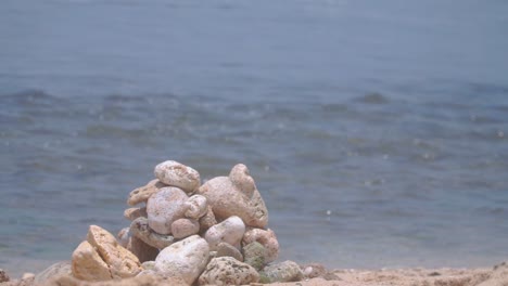 focused pile of coral rocks with blurred sea waves