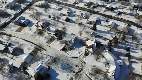 4k drone aerial footage over a small suburb midwest town in the winter with snow