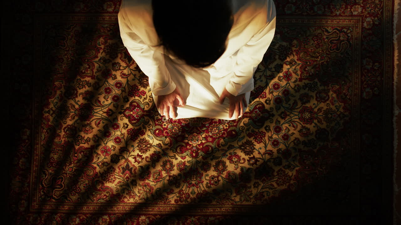Kneeling Man Prays For Ramadan On The Carpet