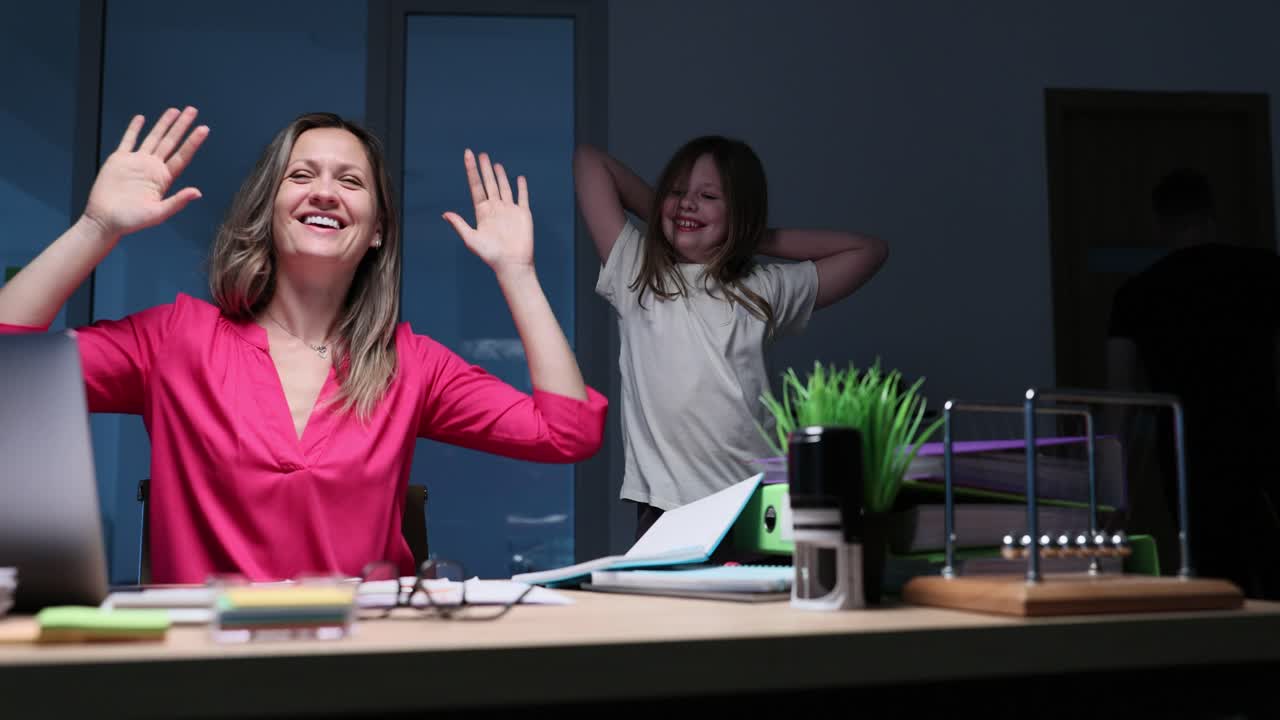 People celebrating and dancing in office