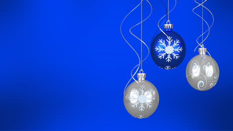 Animation-of-christmas-baubles-over-blue-background