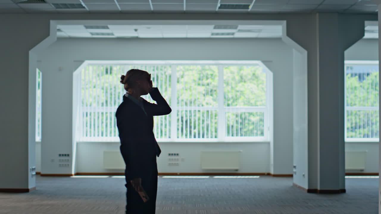Businesswoman silhouette shouting mobile phone ending call at office parking