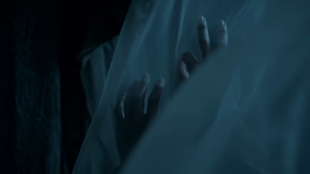 Pale Hands Pressing Through Translucent Veil Fabric, Moody Blue Lighting And Slow Reveal Create Suspenseful