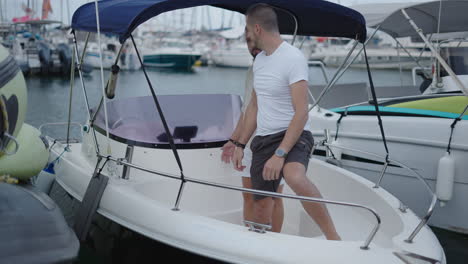 two men on a boat in a marina