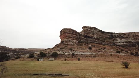 drone shot of a sandstone formation cliff in clarens in the foothills of the maluti mountains, south africa