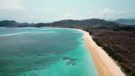 drone flying high above tropical beach in lombok, indonesia