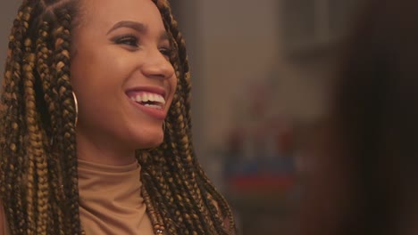 young black woman with braids laughing and smiling very happy in slow motion