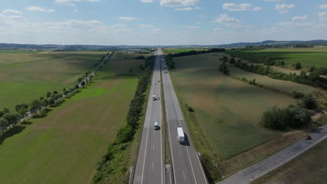 aerial view of a highway cutting through lush green countryside