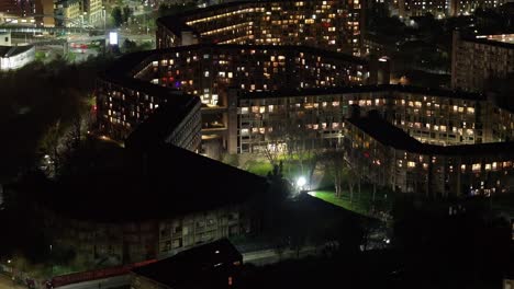 modern apartment buildings at night in sheffield, uk, rising aerial
