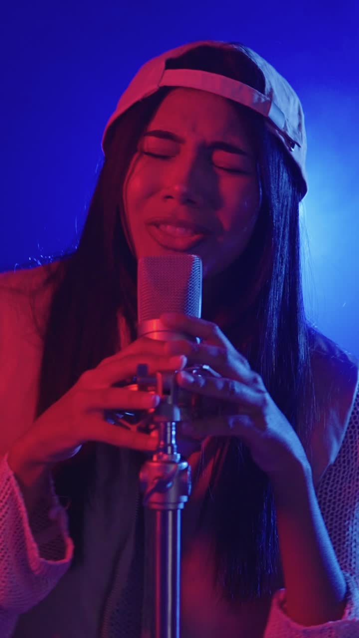 Woman singing into a microphone