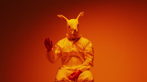 person in a rabbit mask and protective suit