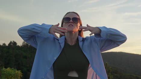 woman calming herself down in the nature, fashion