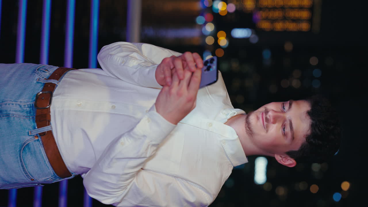 Man using smartphone at night in the city