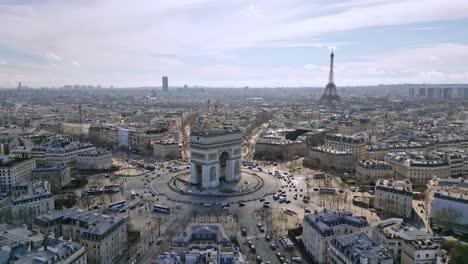 triumphal arch or arc de triomphe with tour eiffel and montparnasse tower in background, paris cityscape, france