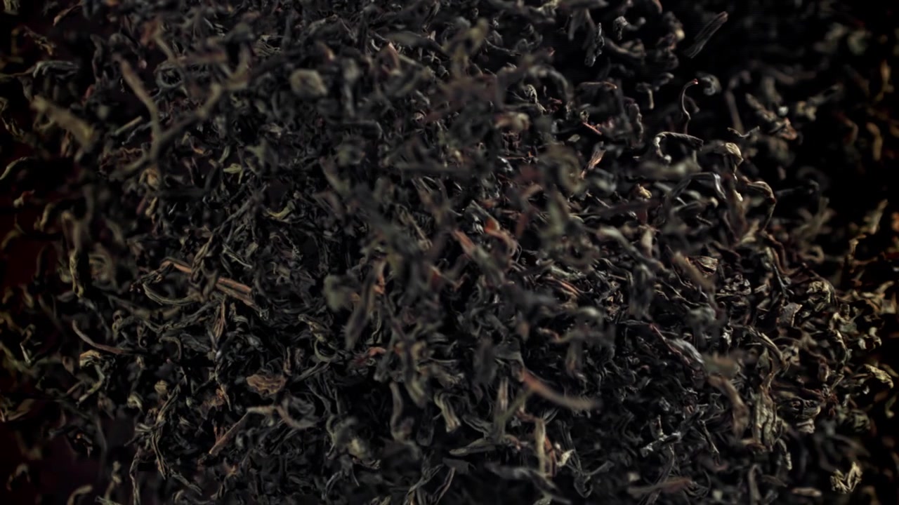 Dry Black Tea Leaves Rising in Slow Motion