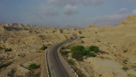 aerial along empty highway road through rugged hingol national park in balochistan desert landscape