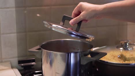 taking of the pot lid and steam comes out of it