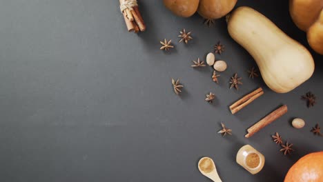 Video-of-pumpkins-with-autumn-spices-on-black-background