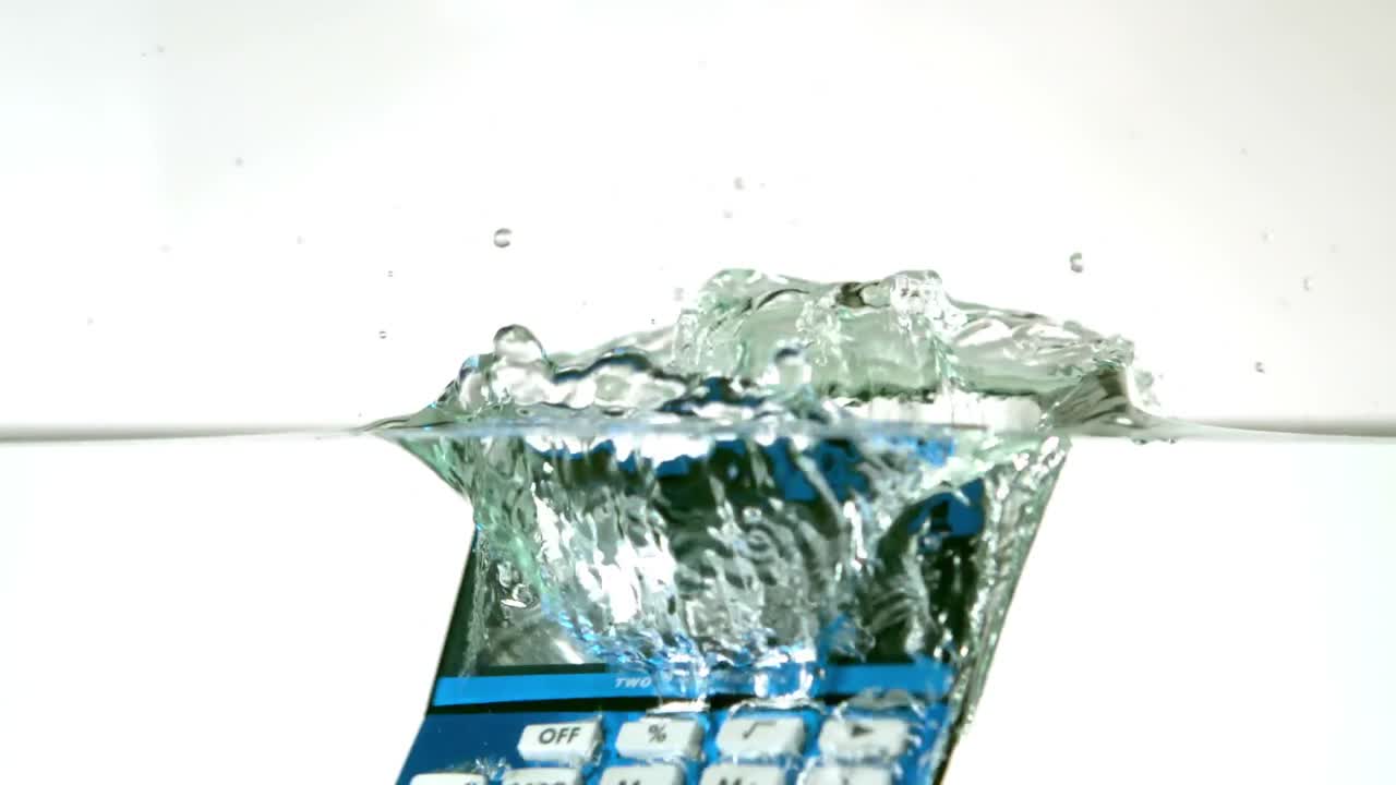 Blue calculator falling into water