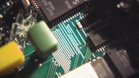 macro closeup of circuit board intricacies and soldered cable wires to chips