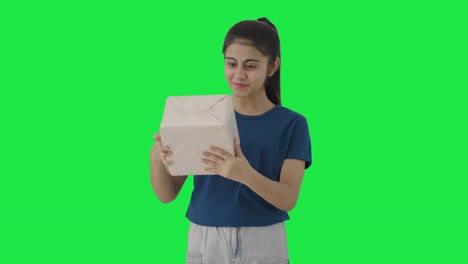 happy indian teenage receiving a gift green screen