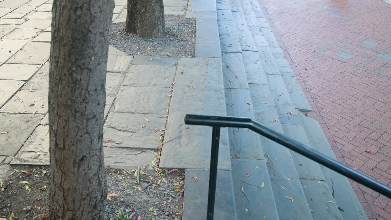 Diverse women walking stone steps past metal rail, foot appearing, passing camera, heading indoors