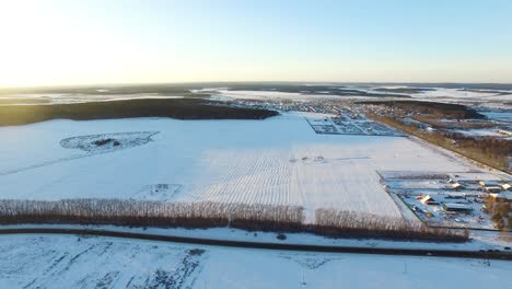 snowy landscape with rural development and road