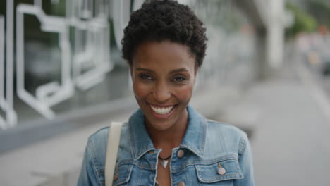 portrait-of-african-american-woman-laughing-cheerful-looking-at-camera-enjoying-relaxed-urban-lifestyle-satisfaction-in-city-street-background