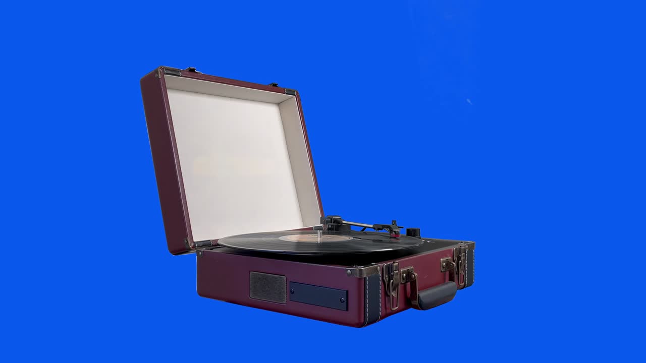 Open Vintage Suitcase Vinyl Turntable Isolated on Blue Background. Zoom In. Close Up. 4K Resolution.