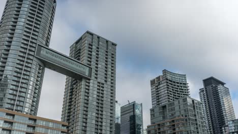 clouds move over apartment skyscrapers in central toronto, timelapse