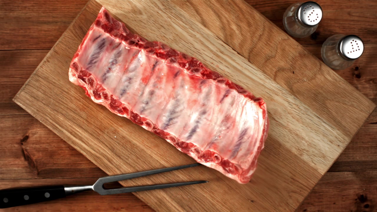 Fresh Raw Pork Ribs on a Wooden Cutting Board
