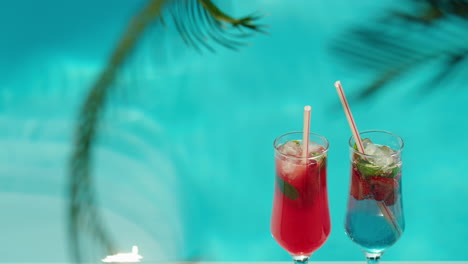 two refreshing cocktails by the pool