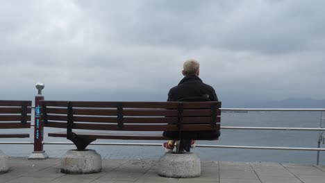 sitting bench across sea