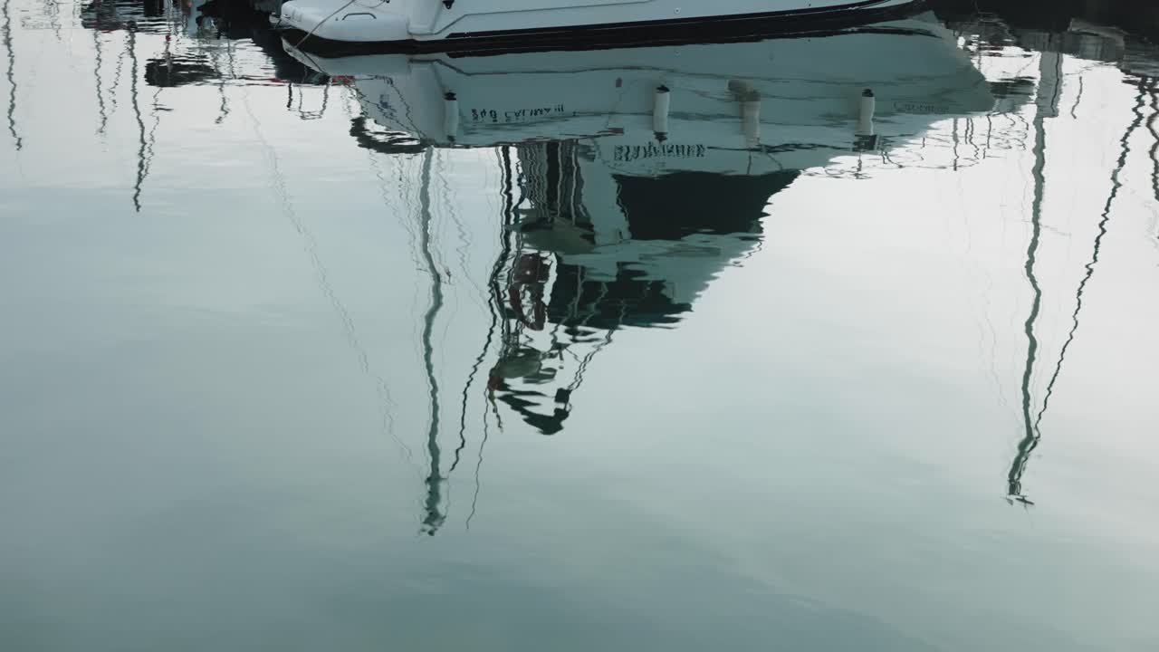 Still Water Reflection of Boat in Town Port