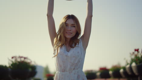 attractive girl taking off sunhat in sunny day. young lady enjoying springtime.