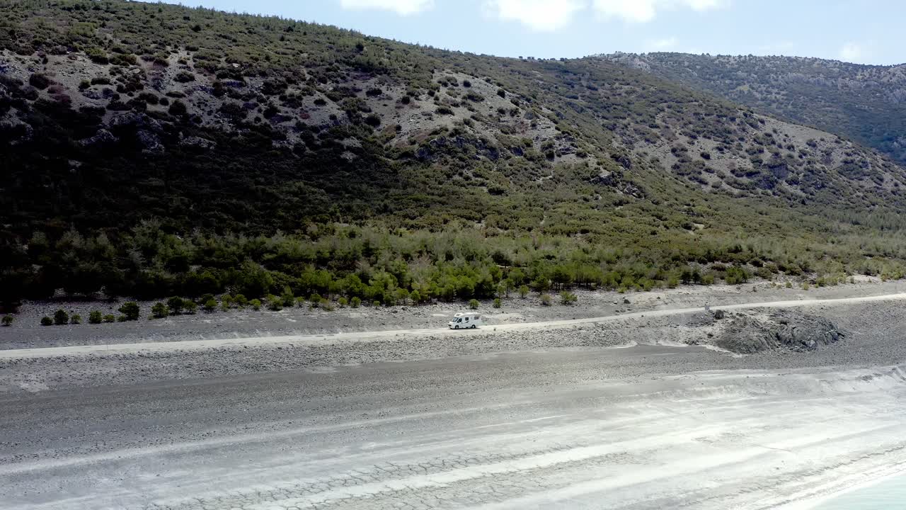Motorhome on Turkish road trip travels along shoreline of Lake Salda drone shot track