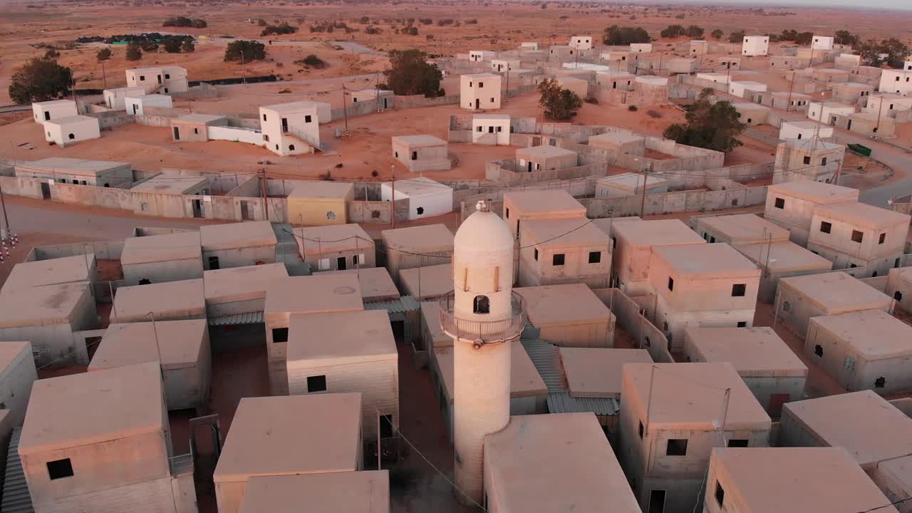 aerial shot of an old mosque at an empty city in the desert in palestine near Gaza at morning