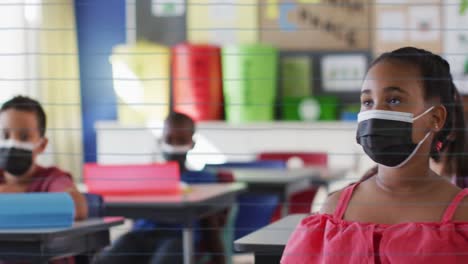 animation of school icons over schoolchildren with face masks and teacher in classroom